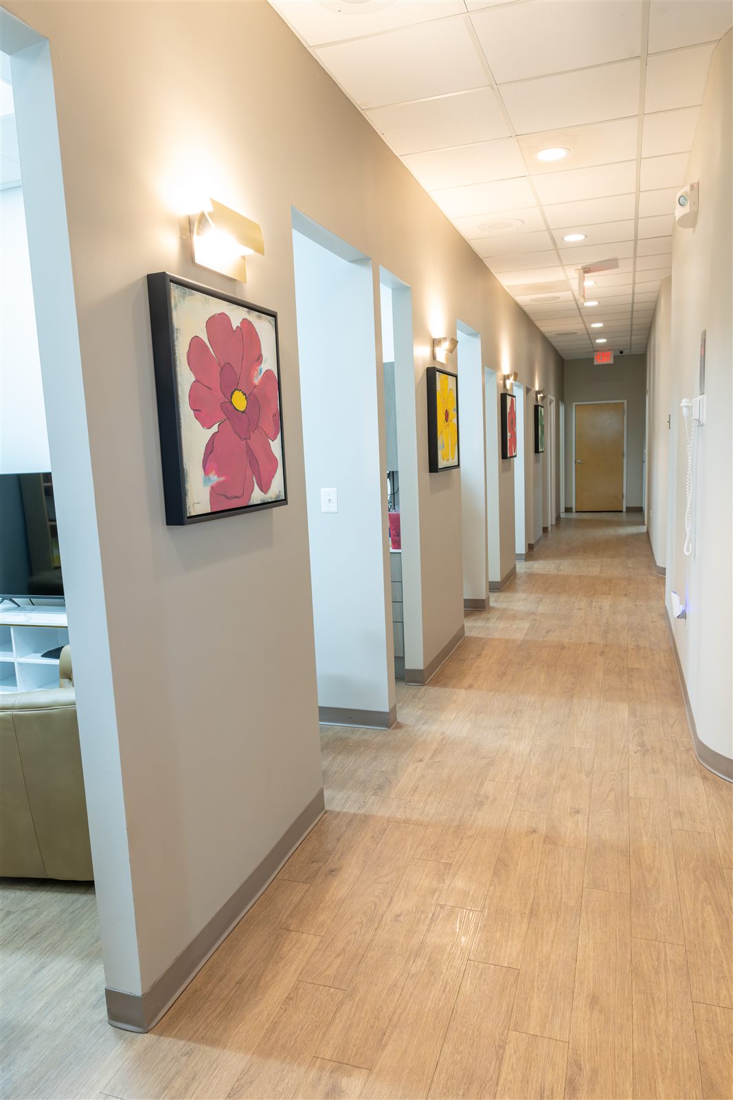 Clean hallway connecting treatment rooms at Luxe Dental Care