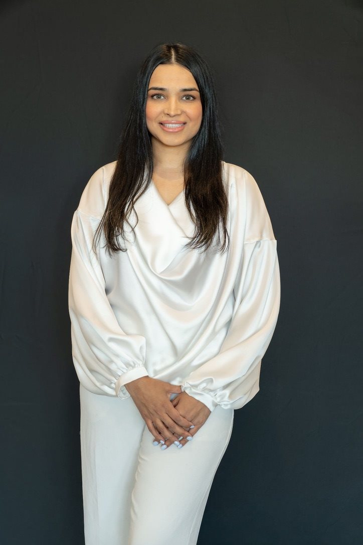 Dr. Aisha Sadaf in a white professional outfit