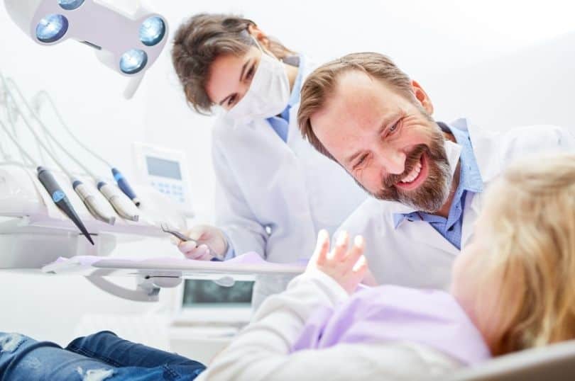 Two Pediatric Orthodontics are talking to a child