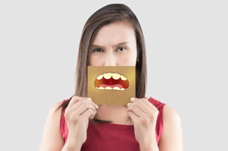 Woman showing unpleasant mouth image