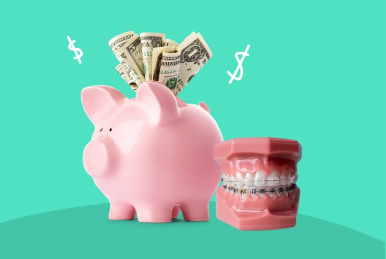 Piggy bank beside ceramic braces dental model