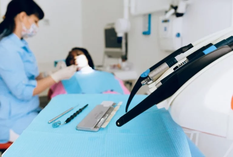 A woman dentist is providing services to her patient